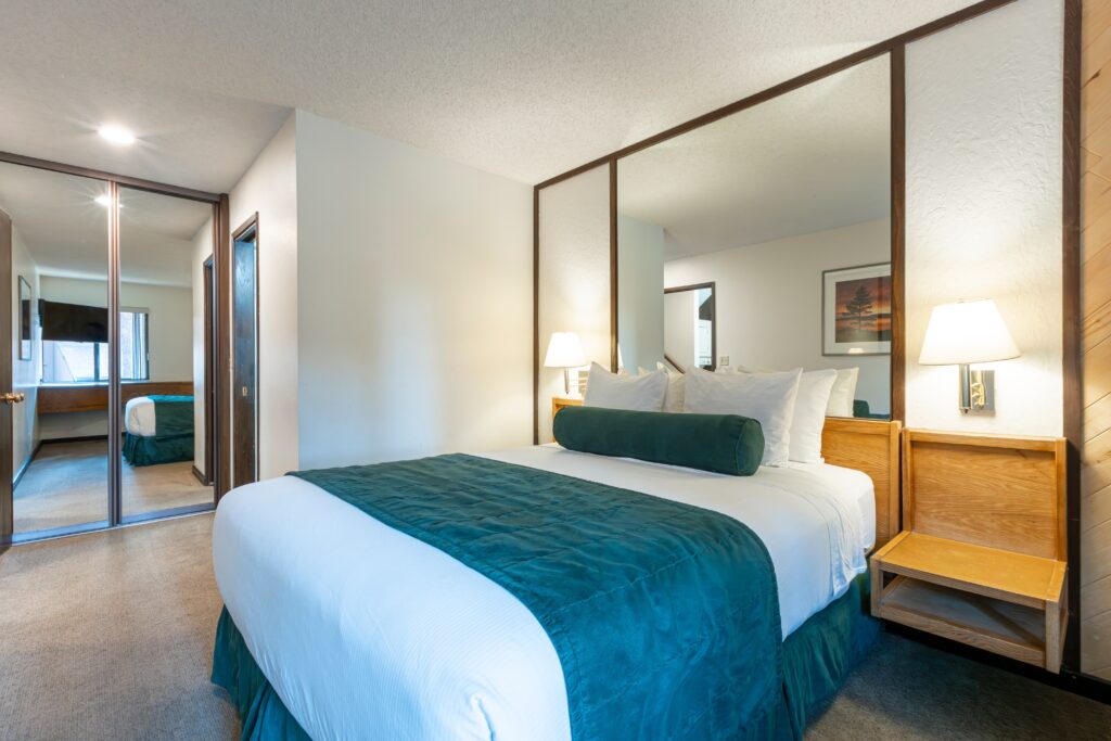 bed in front of mirror