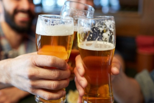 three hands cheersing with beer